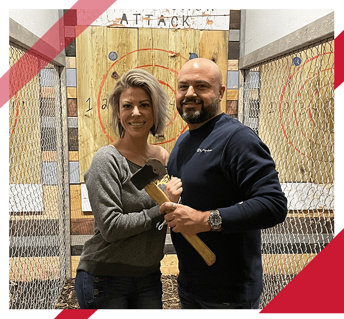 man and woman on a date at an axe throwing range