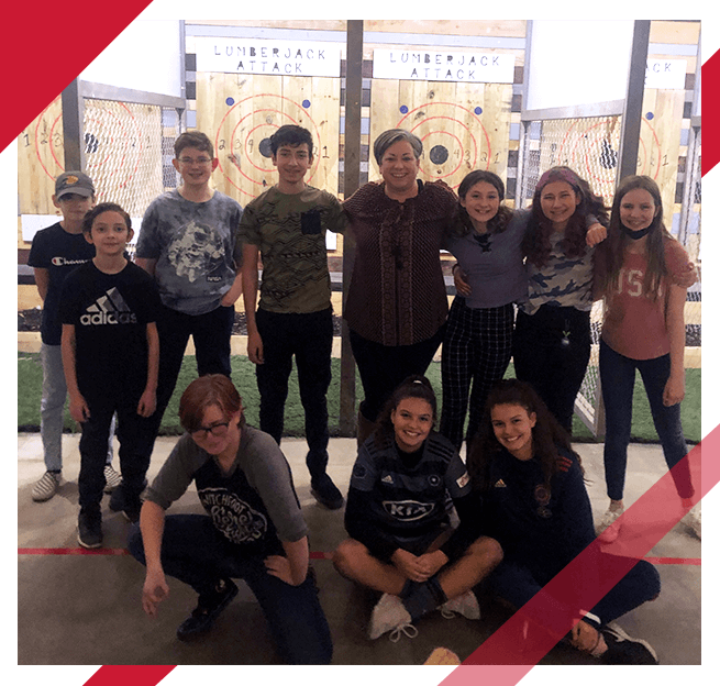 kids and adult at a fundraiser at an axe throwing range